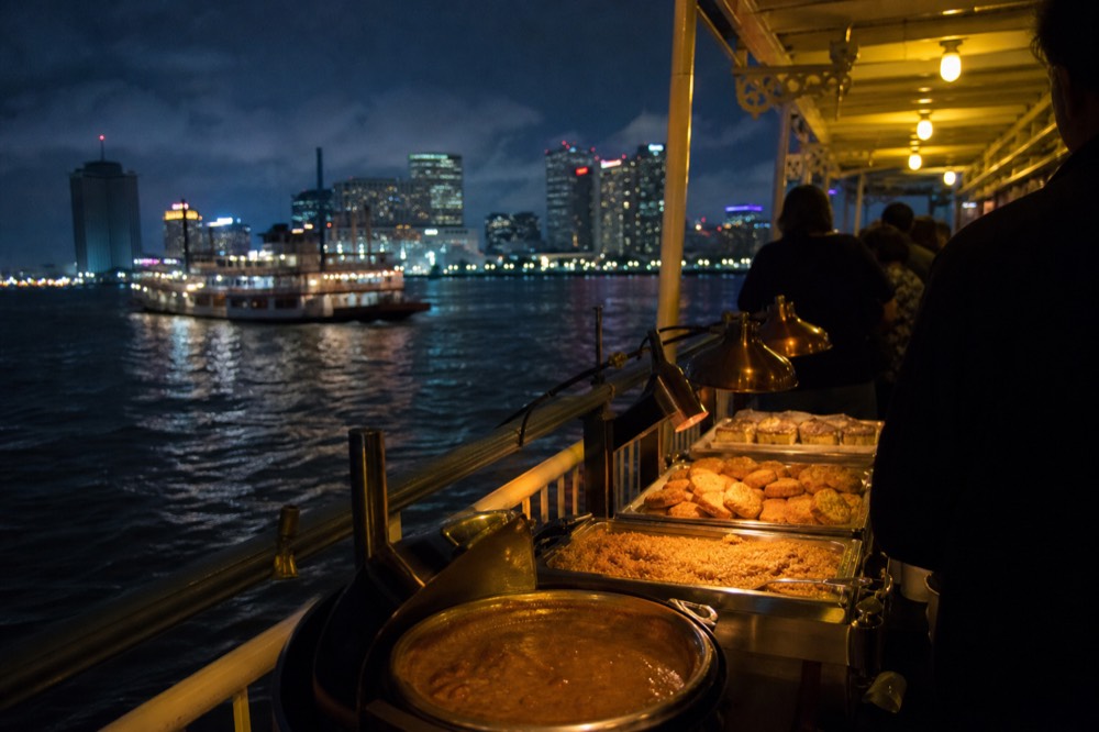 Buffet line on a riverboat with gumbo, jambalaya and bread pudding under warm service lamps