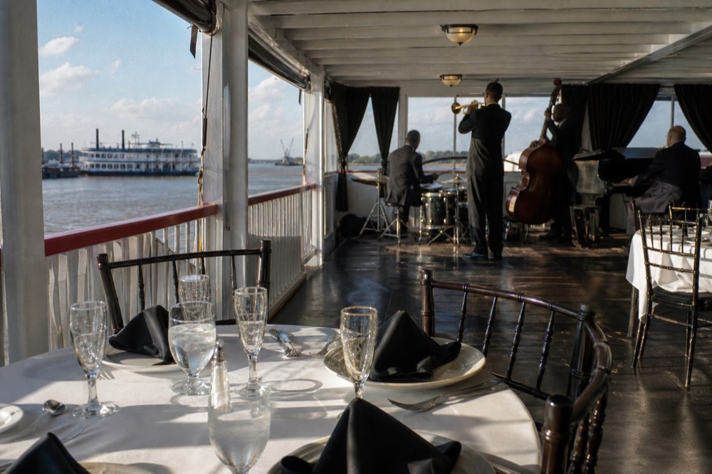 Reserved table set with champagne glasses directly in front of a jazz band stand in a riverboat dining room